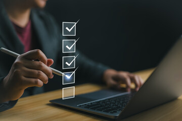 Business performance checklist, businessman using laptop doing online checklist survey, filling out digital form checklist, take an assessment, questionnaire, evaluation, online survey, online exam.