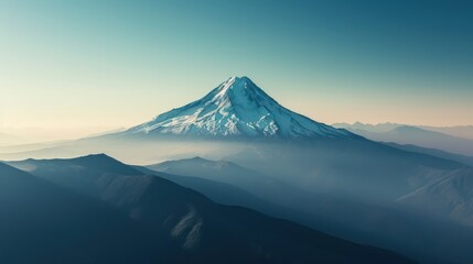 Fototapeta premium Aerial view of a lone, snow-capped mountain peak