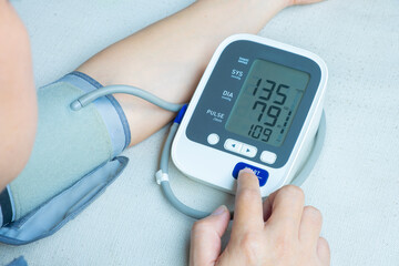 	
Man check blood pressure monitor and heart rate monitor with digital pressure gauge. Health care and Medical concept	
