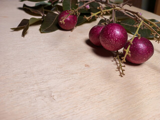 Fototapeta na wymiar new red longan fruit picked on a wooden table