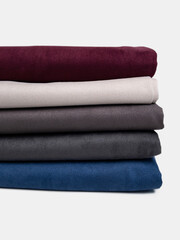 Multi colored fabrics folded in a stack . Multi-colored suede textile. Chamois leather