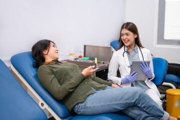 female doctor in uniform gives advice to a female patient lying on bed at hospital