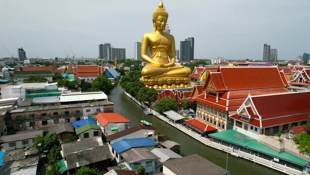 Golden Buddha Statue Wat Paknam Bhasicharoen in Phasi Charoen District in Bangkok Near 
Chao Phraya River Cruise
Thailand - aerial pull back