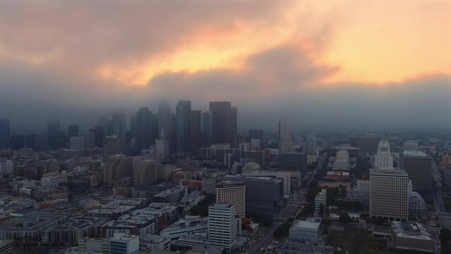Panning aerial shot of sprawling Los Angeles skyline at golden hour