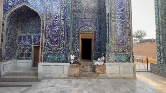 Couple Admires Tuman Aqa Mausoleum, Samarkand, Uzbekistan. Dive into Timurid Dynasty's Legacy in UNESCO-listed Shah-i-Zinda. Silk Road's Blend of Persian and Central Asian Influences.