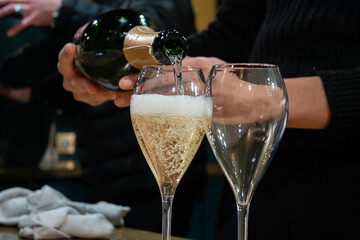 Tasting of sparkling wine champagne on winter weekend festival in December on Avenue de Champagne,...