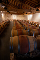 French oak wooden barrels for aging red wine in cellar, Saint-Emilion wine making region picking,...