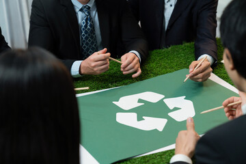 Recycle icon on meeting table in office with business people planning eco business investment on...