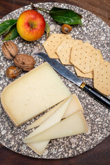 Piece of tasty Ossau-Iraty or Esquirrou sheep cheese produced in south-western France, Northern...