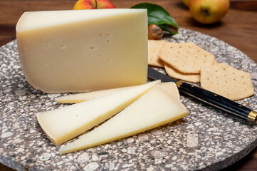 Piece of tasty Ossau-Iraty or Esquirrou sheep cheese produced in south-western France, Northern...