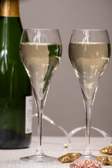 Glasses of bubble wine champagne, cremant, cava or prosecco and christmas stars for decoration