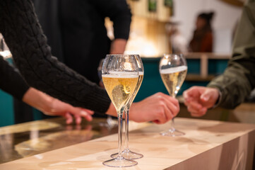 Tasting of sparkling wine champagne on winter weekend festival in December on Avenue de Champagne,...