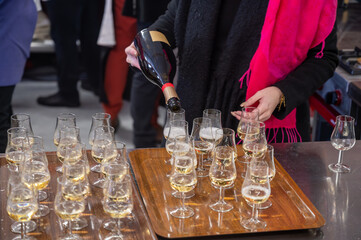 Many small tasting glasses of sparkling wine champagne on winter festival in December, Avenue de Champagne, Epernay, Champagne region, France