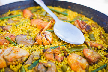 Valencian paella with a focus on spoon.