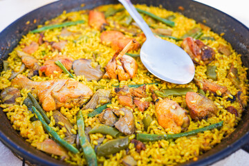 Close-up of a traditional Valencian paella with various ingredients.