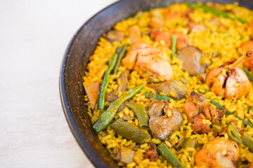 Close-up of a traditional Valencian paella with various ingredients.