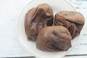3 pieces of chocolate bread filled with chocolate jam in a white plate on the table