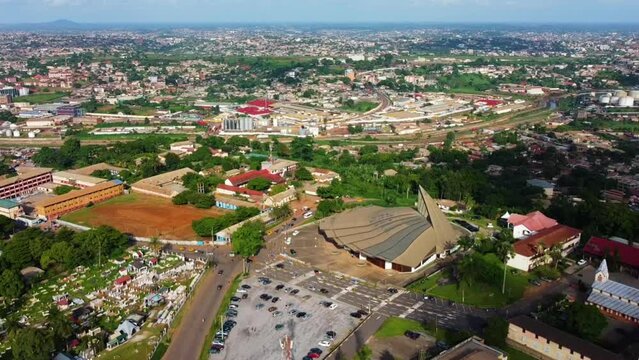 Aerial overview of the Basilica of Mary Queen of Apostles, in Cameroon - pull back, drone shot