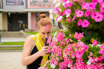 Fototapeta premium Young woman with flowers in the city of Poprad in Slovakia