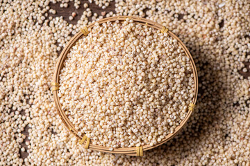 Sorghum seeds in bamboo basket closeup. Whole seeds of Sorghum Moench