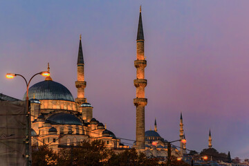 Fototapeta na wymiar The Yeni Cami or New Mosque illuminated in the morning at sunrise on the Historic Peninsula in Istanbul, Turkey