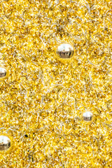 Golden Christmas fir branches background. Festive xmas decoration gold bauble and bright fir branches. 