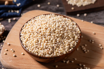 Sorghum seeds in plate on wooden table. Whole seeds of Sorghum Moench