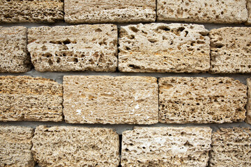 Porous surface of gray building stone. Repair and construction. Close-up. Space for text. Background.