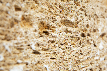 Porous surface of gray building stone. Repair and construction. Close-up. Space for text. Background.