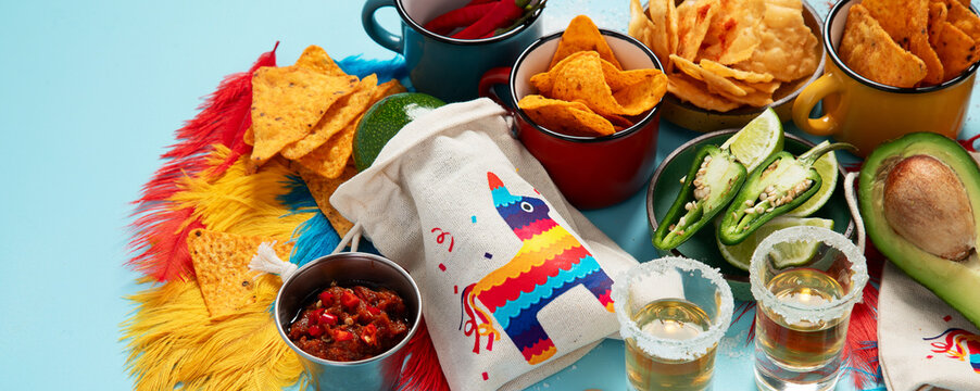 Cinco de mayo party food. Mexican holiday traditional dishes, snacks, tortilla corn chips, nachos, tacos, salsa, sauces.