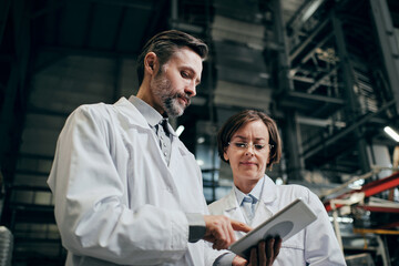 Two engineers working at the factory warehouse