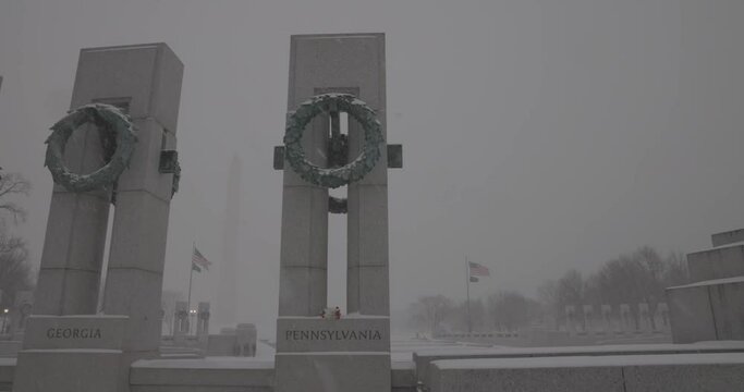 Slow motion video of snow falling near the WWII Memorial in DC.