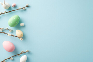 Springtime magic captured: top view of vivid eggs, a cute bunny on a pastel blue backdrop. Personalize with your text