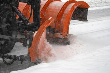 close up on snowplow driving on residential street