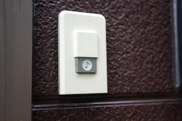 Close-up at doorbell ringing with icon that installed in front of the house. Electric household equipment object.