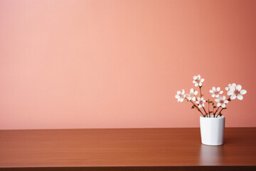 Fototapeta na wymiar Cherry blossom in vase on wooden table and pink background.