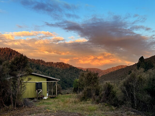 New Zealand cabin or hut in the wilderness at sunset. Kaimanawa Ranges, central North Island. Base...