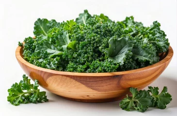Poster fresh kale in wooden bowl, fresh herbs in a bowl, isolated white background © Johan Wahyudi