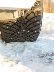 Studded winter tyre on snow. - 709556939