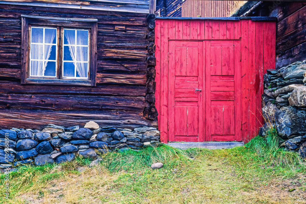 Canvas Prints Red door in an alley with old log houses