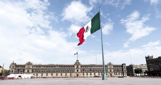 slow motion shot of mexican flag flying on the zocalo totally empty