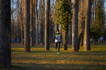Fototapeta premium Mature man running in the park with headphones
