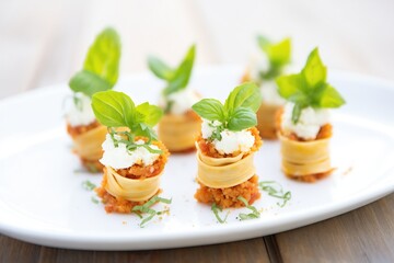 individual lasagna roll-ups with tomato sauce
