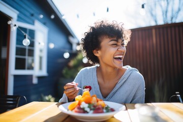 smiling person eating fruit salad on a sunny patio