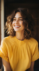 Fototapeta premium Portrait of a smiling young woman in yellow dress looking at camera outdoors