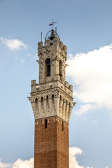 Fototapeta premium Siena, Italy - July 26, 2023: Torre del Mangia in Siena, Italy