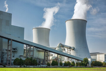 Industrial Cooling Towers Emitting Steam at Power Plant