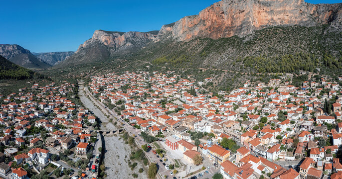 Greece, Leonidio, Arcadia Peloponnese. Aerial drone view panoramic of town, dry Dafnon river bed.