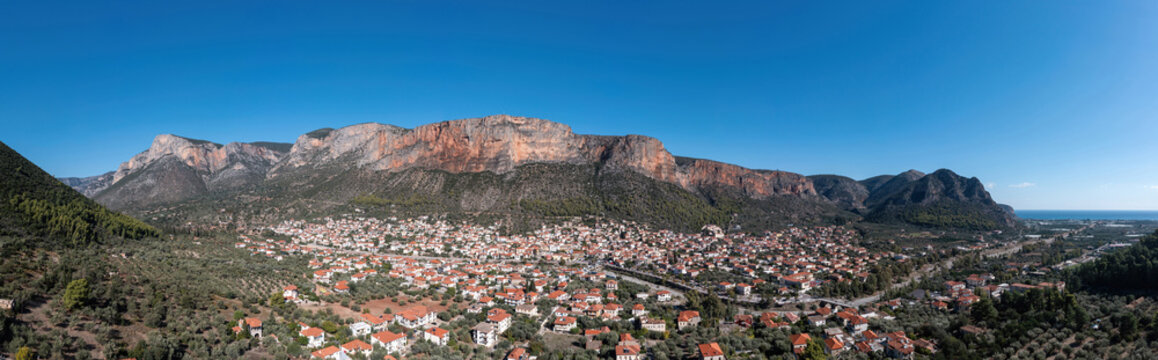 Greece, Leonidio, Arcadia, Peloponnese. Aerial drone panoramic view of town, mountain, cliff. Banner