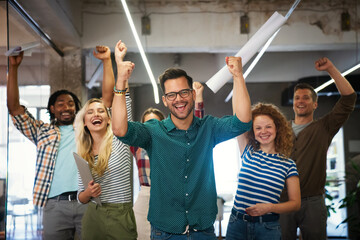 Happy diverse employees team celebrating success, business achievement
